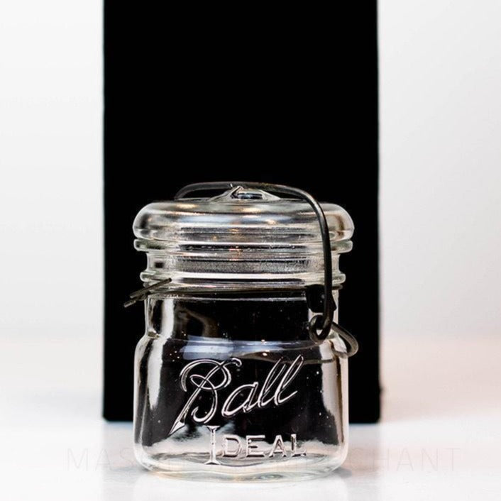 Vintage 1920s Ball wire bail half pint mason jar against a white background