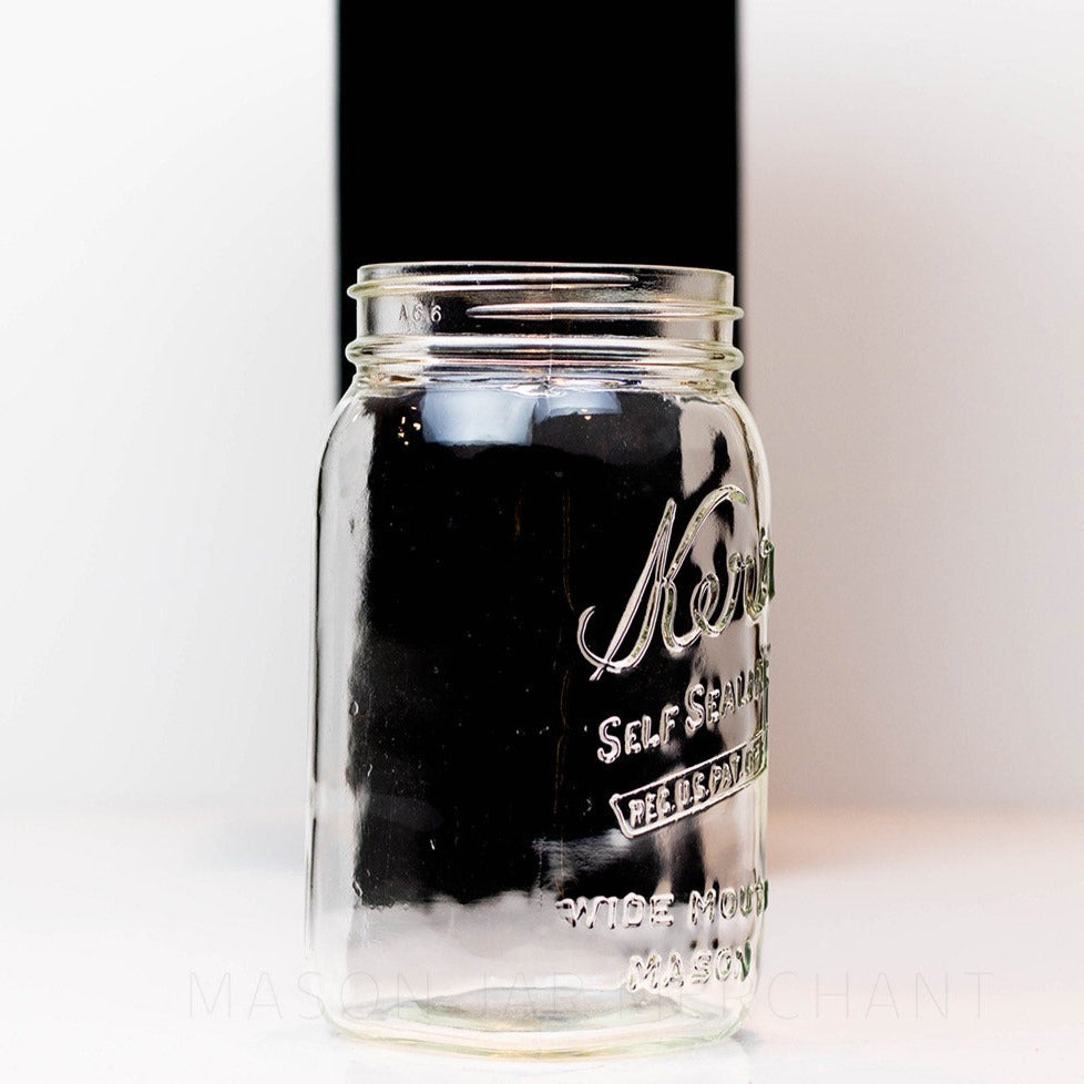 Side view close up of a Wide mouth quart mason jar with Kerr self-sealing logo against a white background