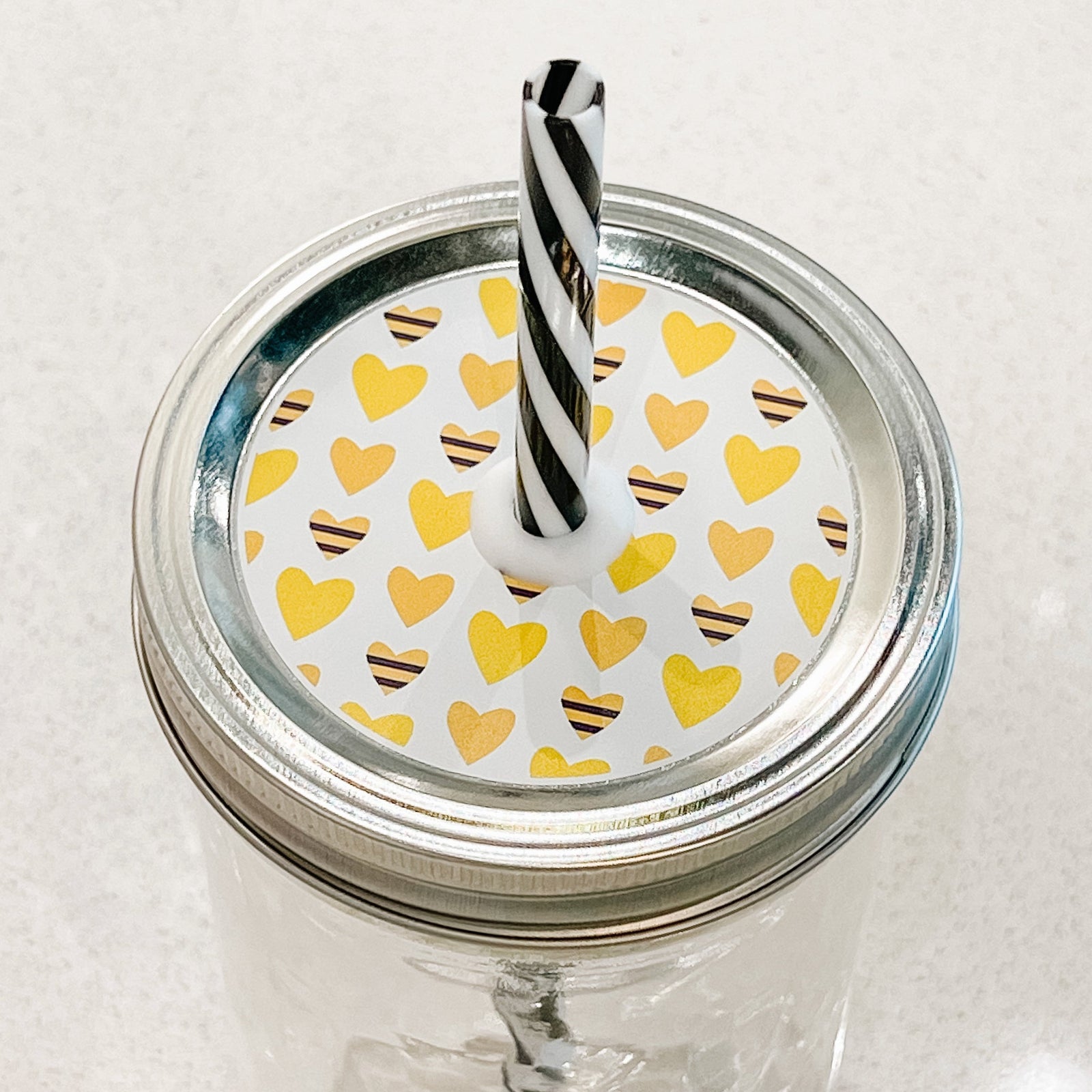 top photo of mason jar lid with a heart colored like a bee And yellow heart