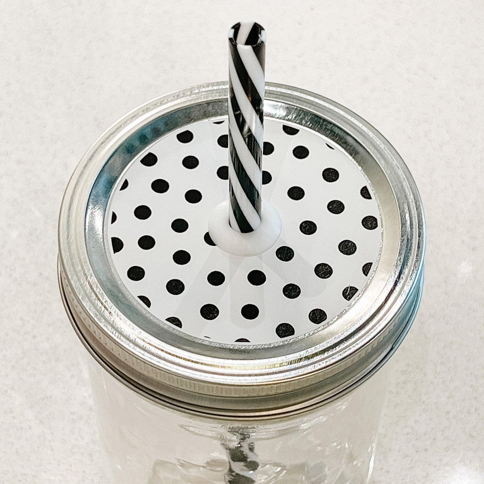 top photo of mason jar lid with black polka dots