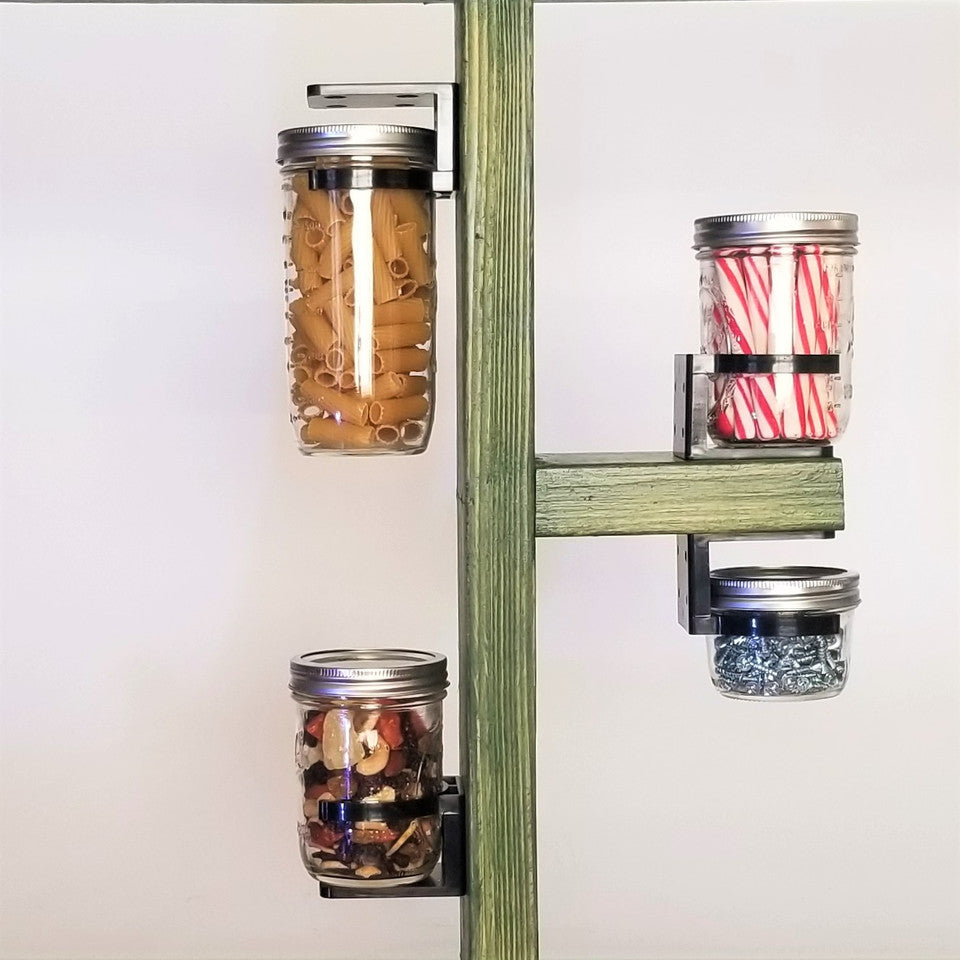 image of jars being held in place by black, plastic clips that are screwed in place on a shelf