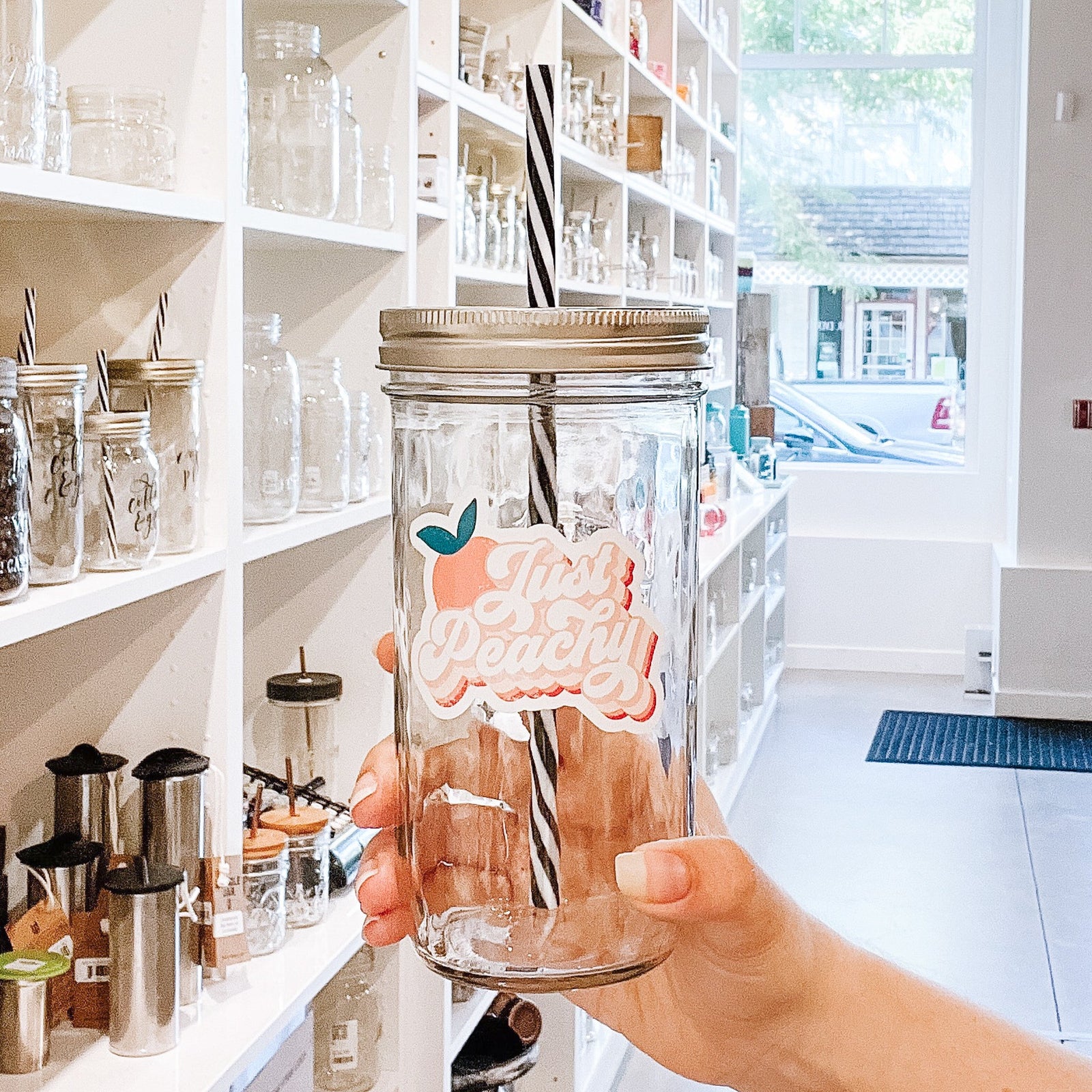 A woman holding a Just Peachy Retro Mason Jar Tumbler