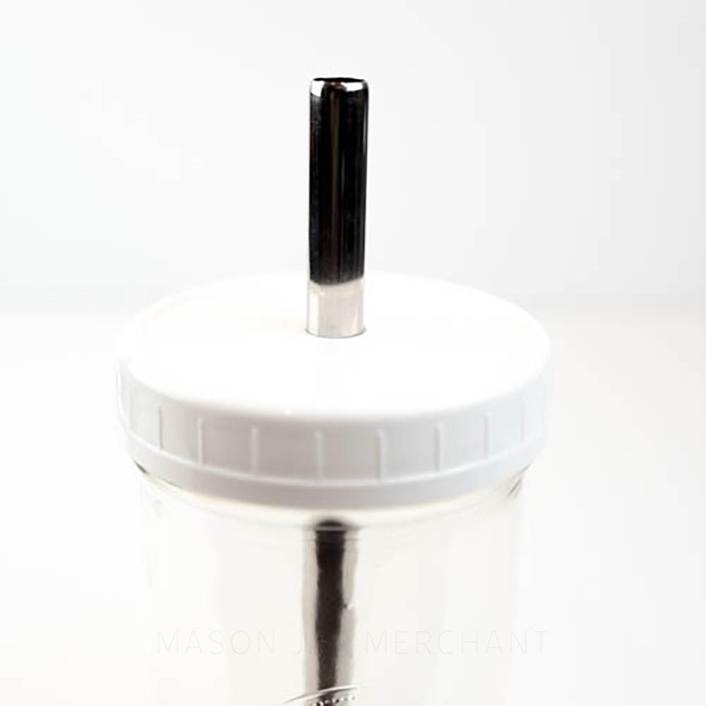 White wide mouth mason jar straw lid on a mason jar, with a stainless steel bubble tea straw