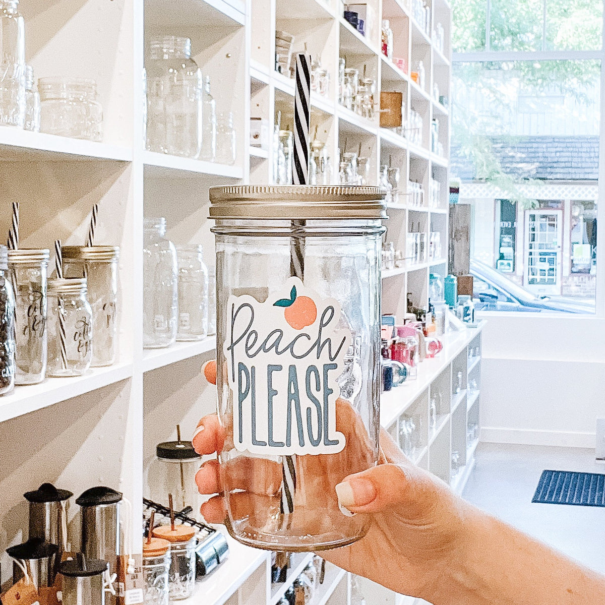 A woman holding a Peach Please Mason Jar Tumbler