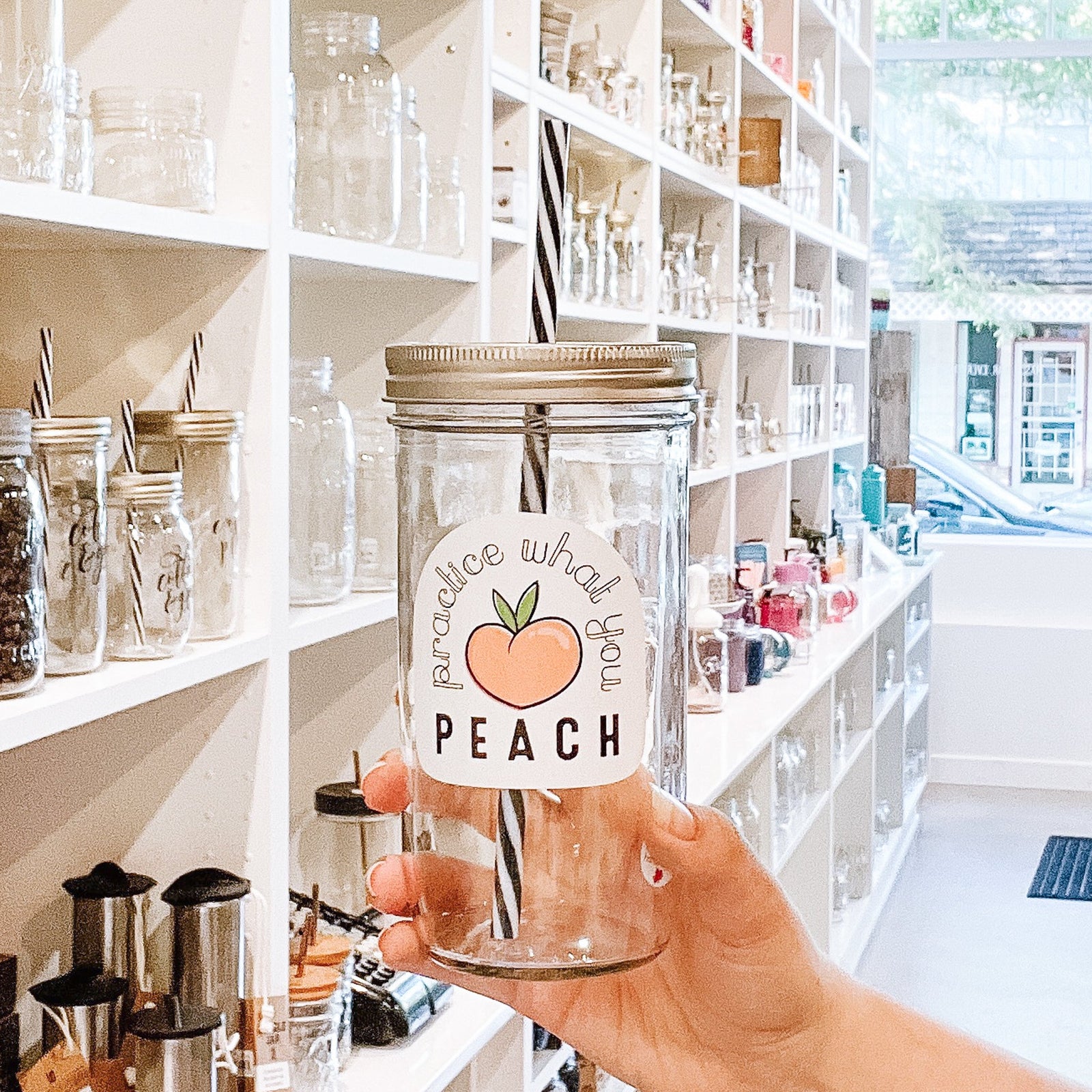 A woman holding a Practice What You Peach Mason Jar Tumbler