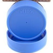 a hand holds a glass reusable mason jar with a pink lid and a spoon on a white kitchen background, the jar is filled with fruit oats and milk