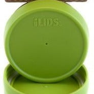 black and white storage lids sit on a counter with a glass jar full of nuts