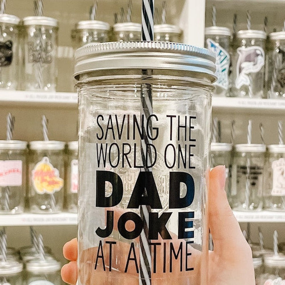Close up of Saving The World One Dad Joke At A Time decal on mason jar tumbler in black text