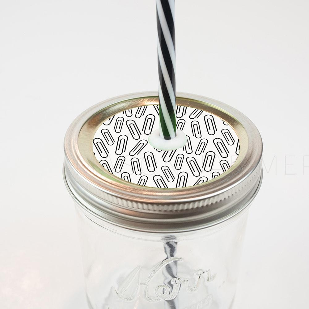 Silver lid with a paper clips on white patterned mason jar straw lid