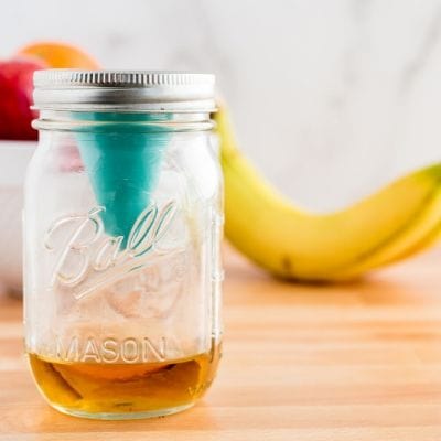 Photo of a mason jar with fruit fly trap.