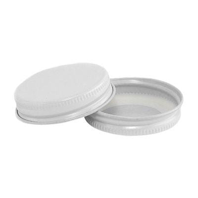 two white mini canning jar lids on a white background