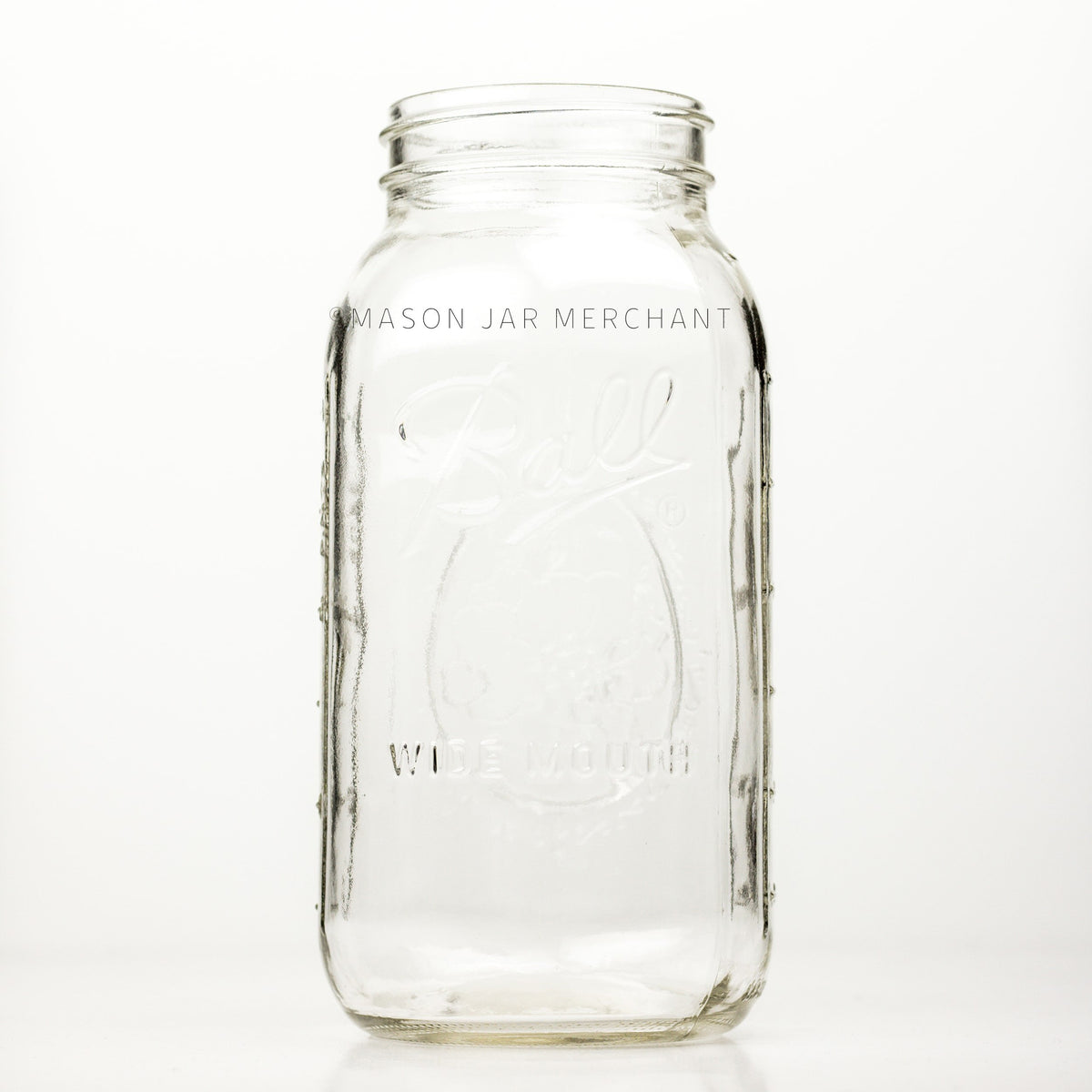 Wide mouth half-gallon mason jar with Ball Wide mouth logo, and fruity oval design visible on the back side of the jar. against a white background