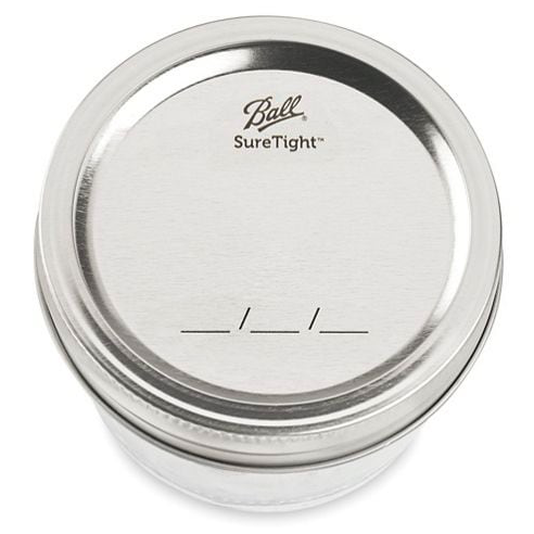 close up of a silver ball wide mouth canning lid on a white background