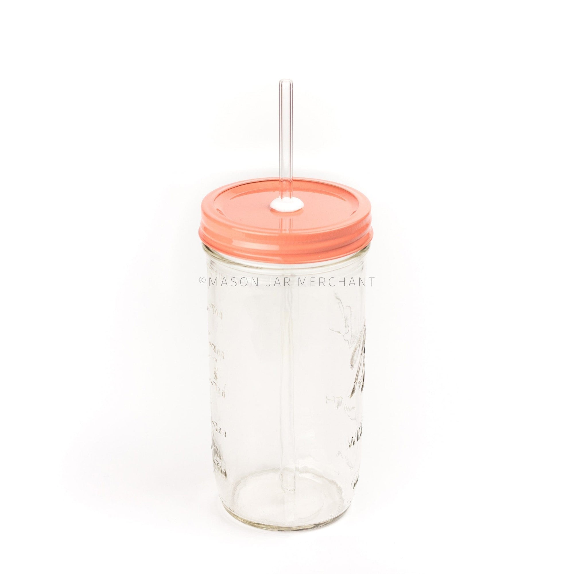 Close-up of a 24 oz mason jar with a coral coloured painted straw lid and a glass straw
