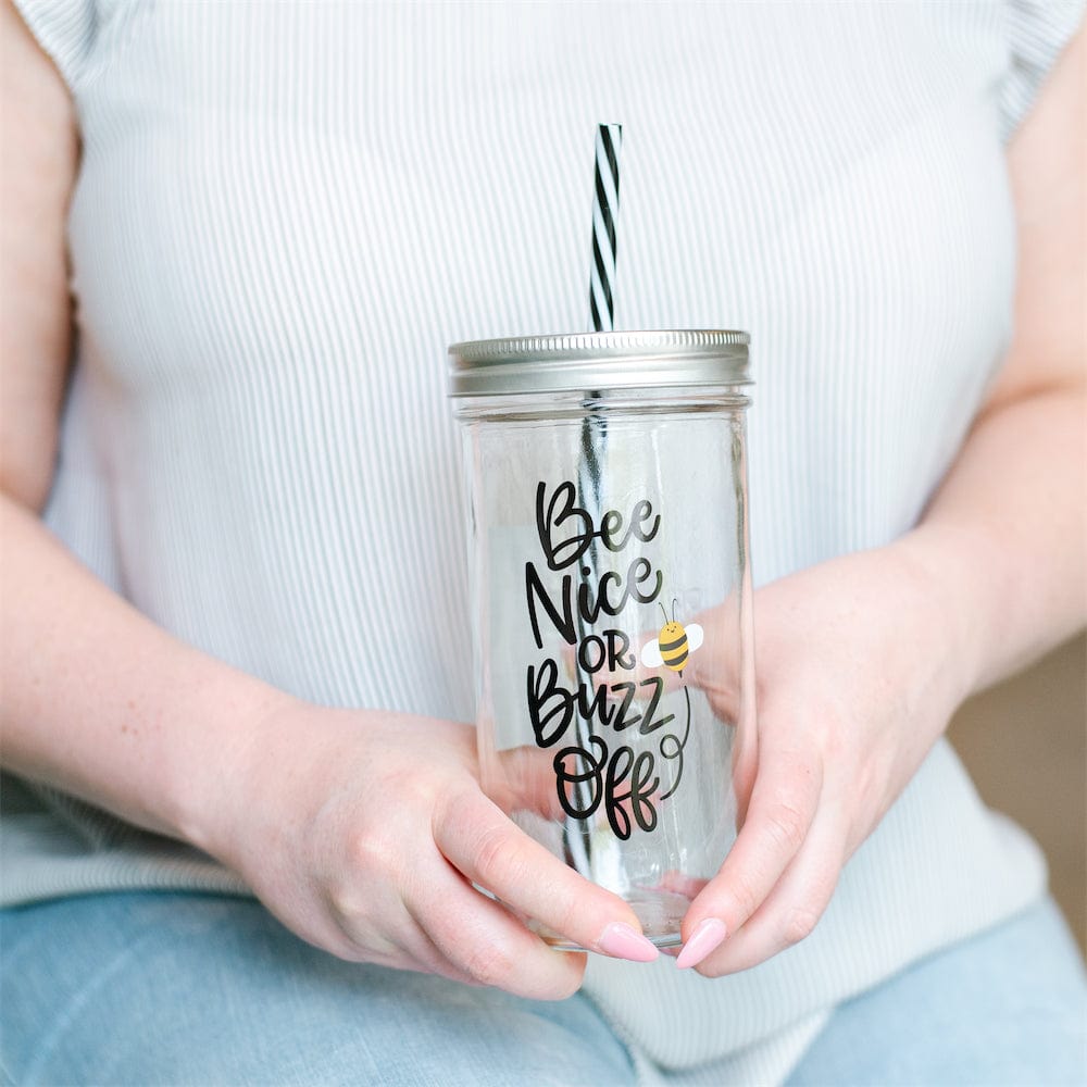 Photo of a mason jar tumbler with a print that says "bee nice or buzz off".