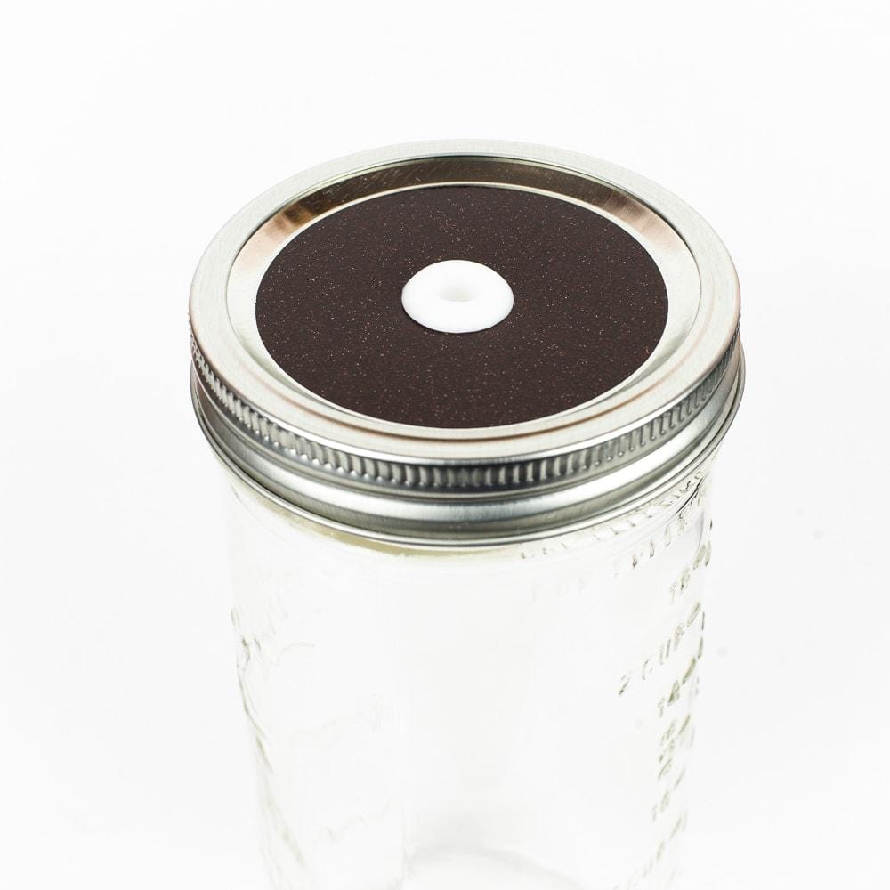 Deep merlot Glitter Mason Jar Straw Lid on a silver lid against a white background.