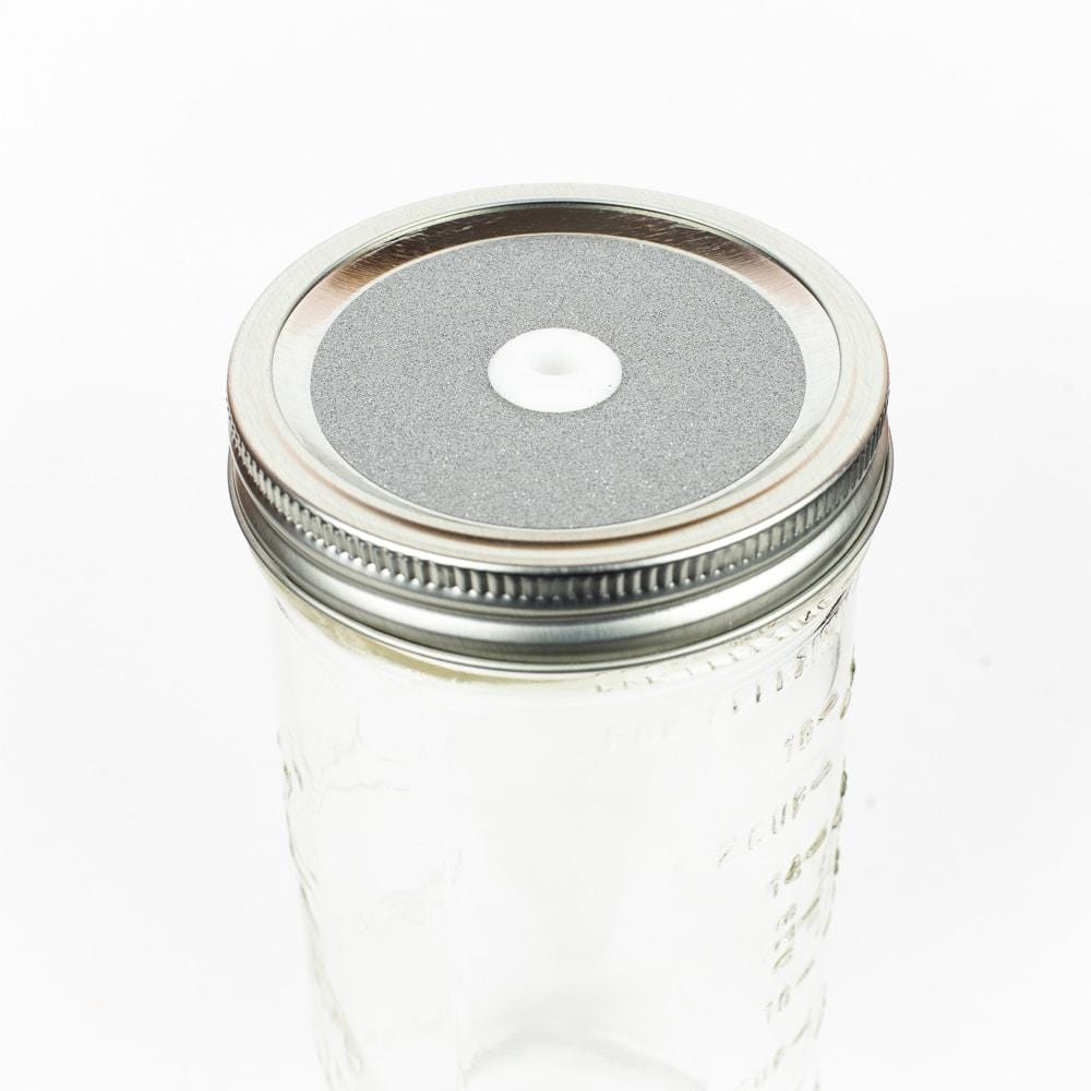 Silver Glitter Mason Jar Straw Lid on a silver lid against a white background.