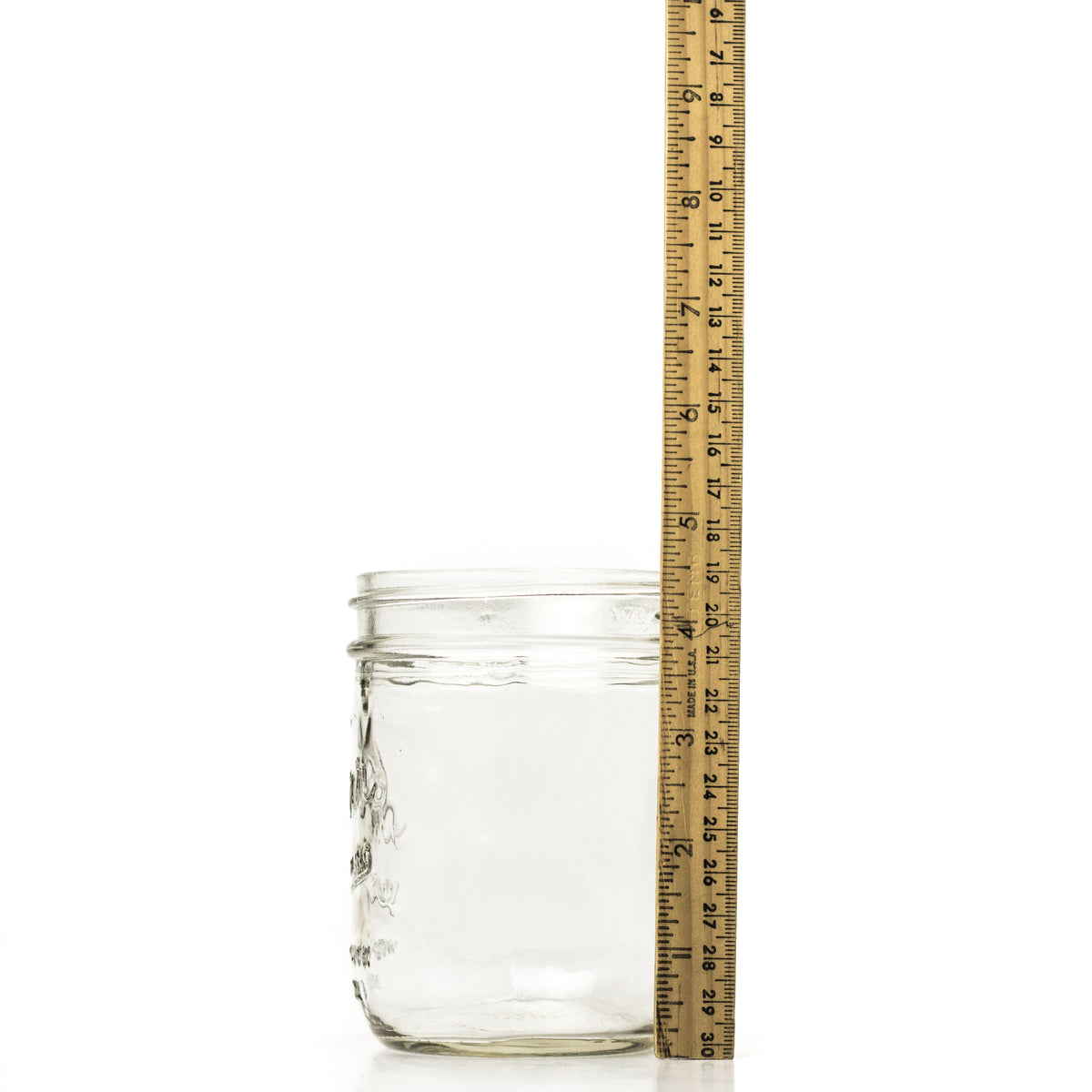 Wide mouth pint mason jar side view with a ruler for height comparison