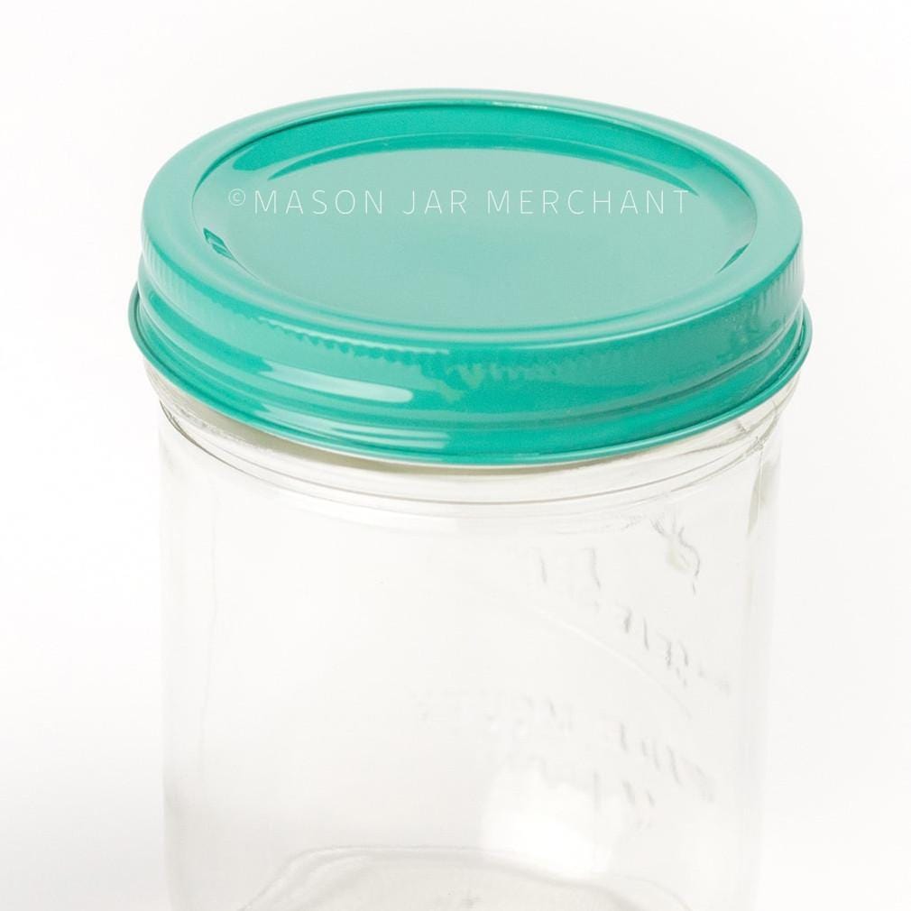 an all turquoise painted lid on a 24 oz glass mason jar