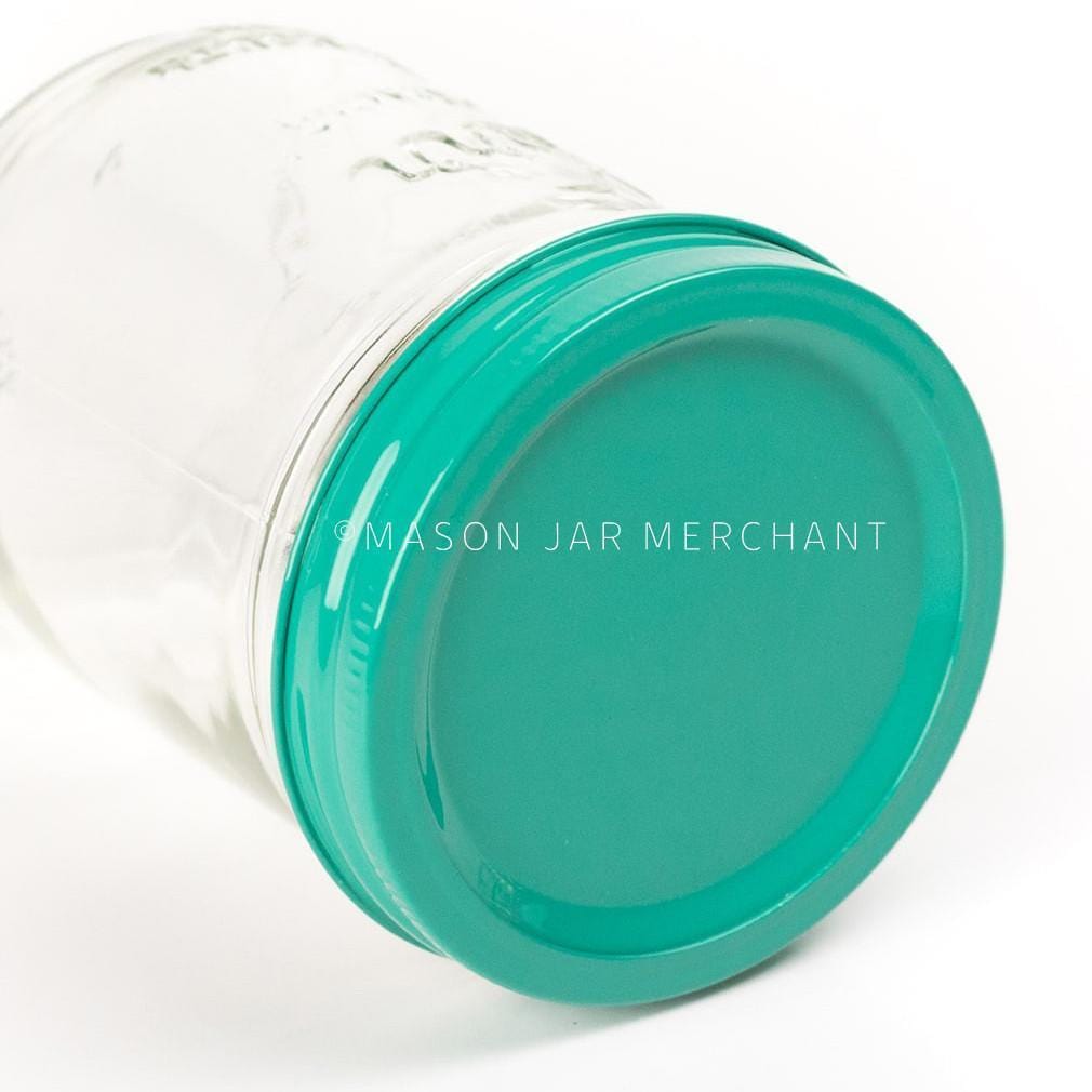 an all turquoise painted lid on a 24 oz glass mason jar