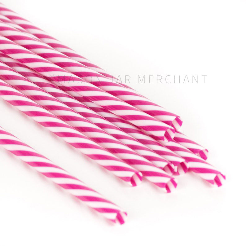 Dark pink and white striped BPA-free reusable plastic straws against a white background