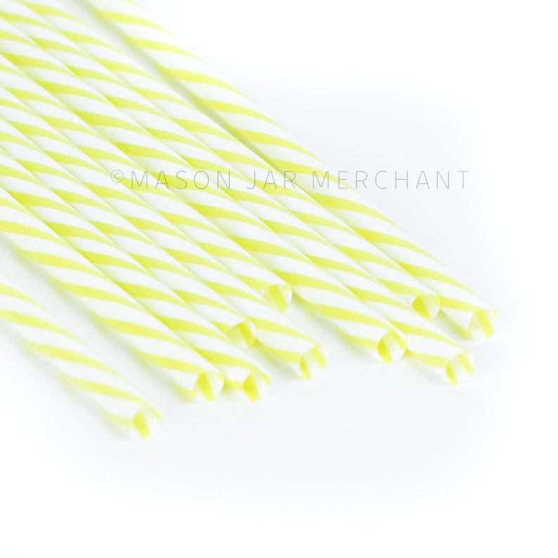 Yellow and white striped BPA-free reusable plastic straws against a white background
