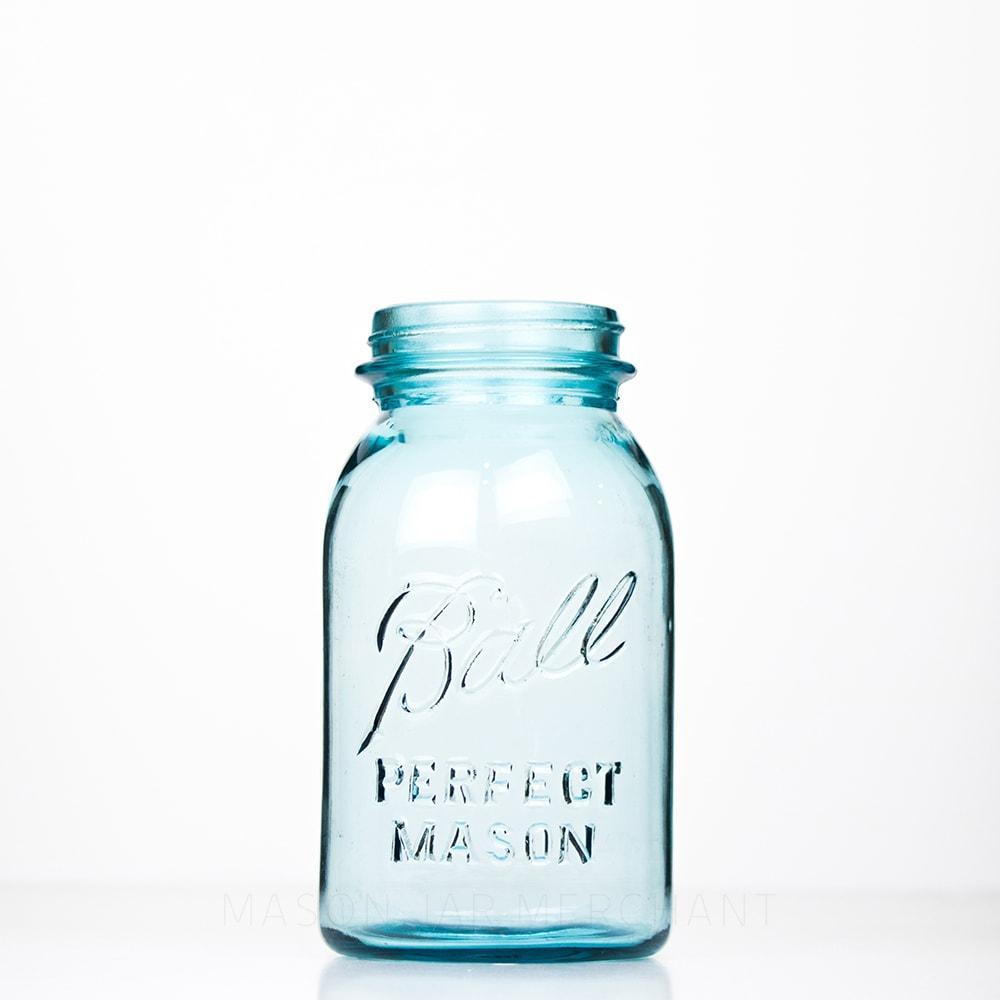Vintage blue Ball regular mouth quart mason jar against a white background 