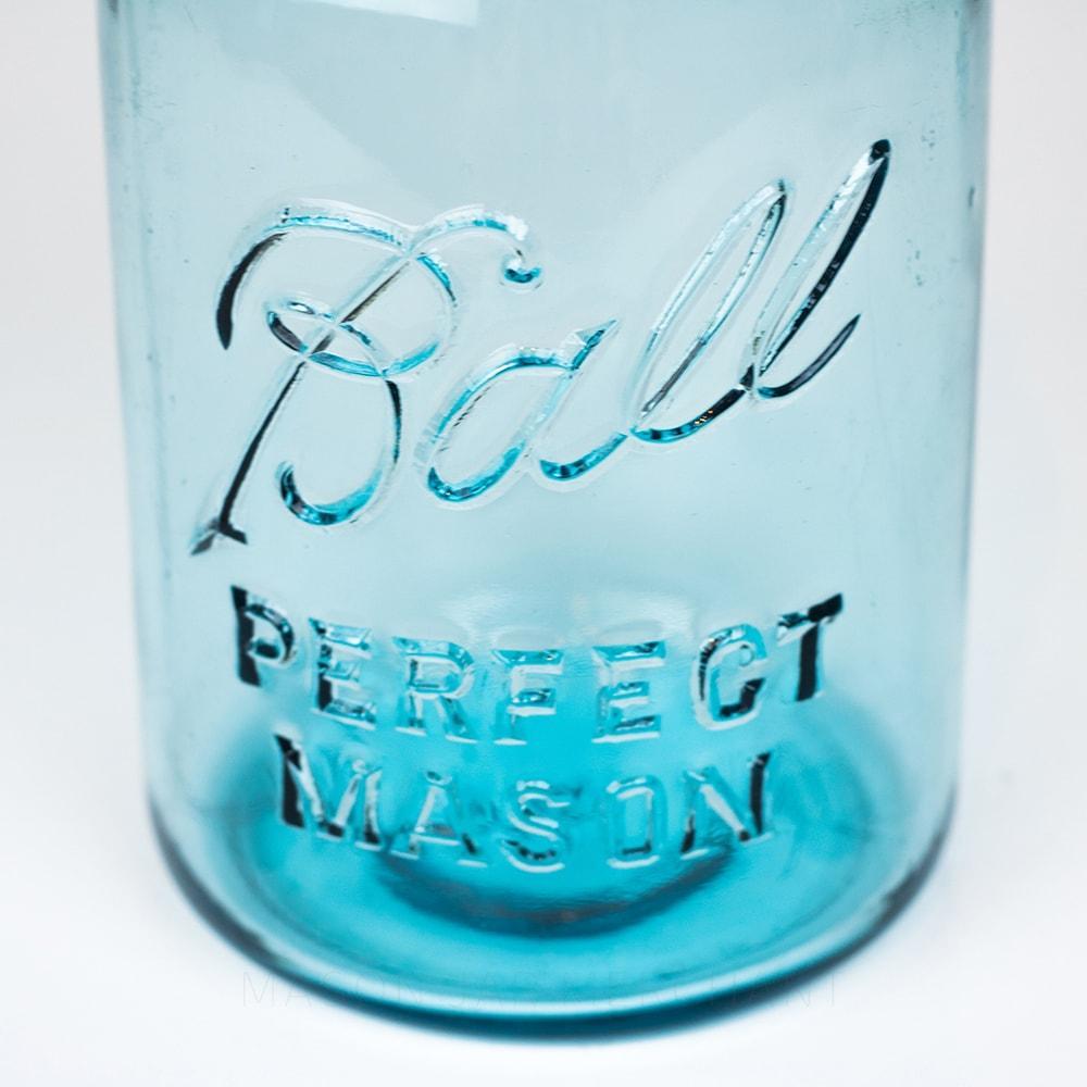 A close up of a Vintage blue Ball regular mouth quart mason jar against a white background