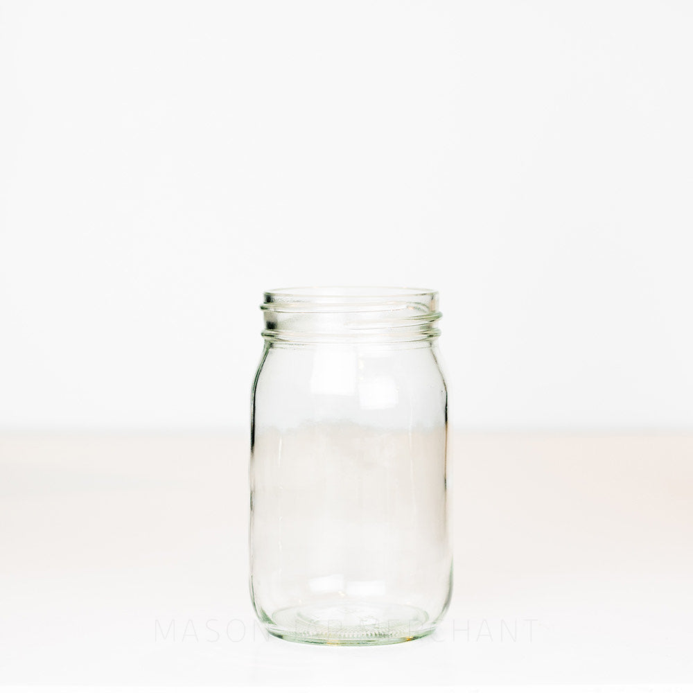 Regular mouth pint mason jar with no logo and plain sides on a white background 