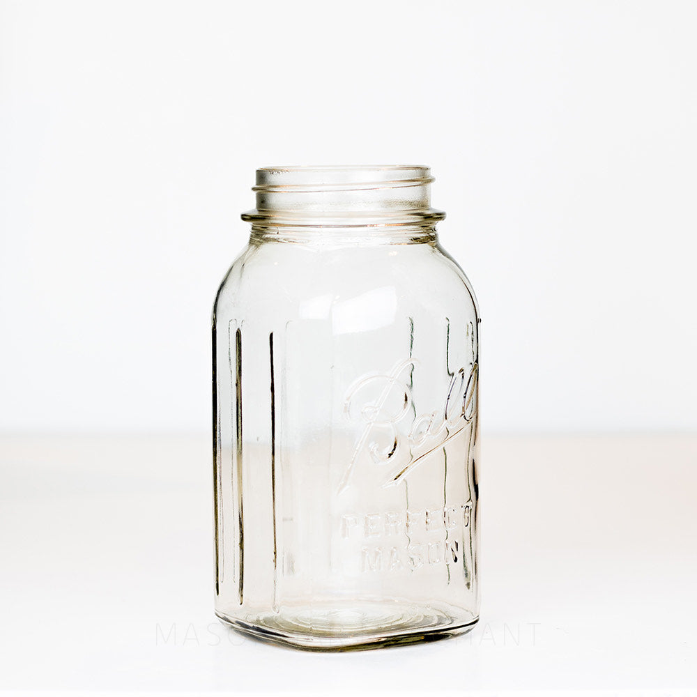 Side view of a Squared Ball regular mouth mason jar with logo showing on a white background