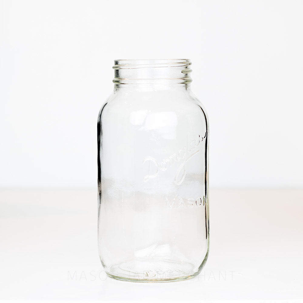 Side view of regular mouth quart mason jar with Domglas logo against a white background
