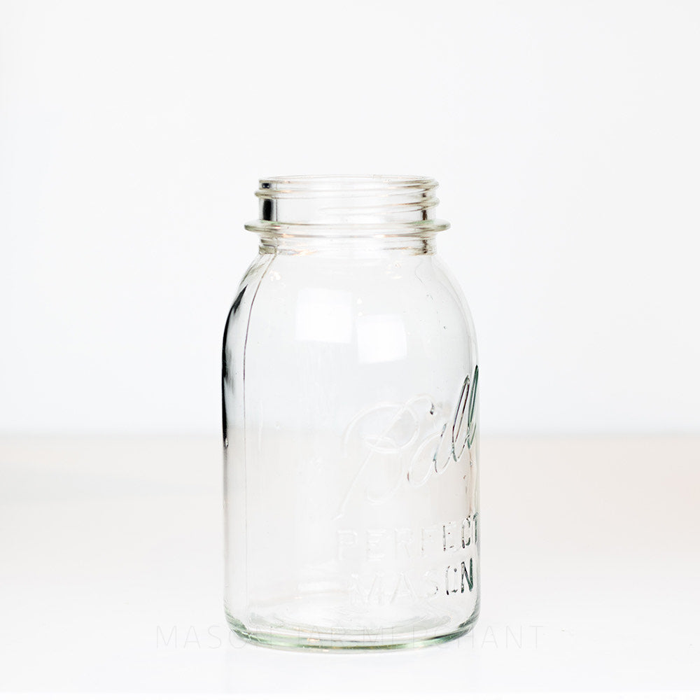 Side view of a vintage Ball quart mason jar against a white background 
