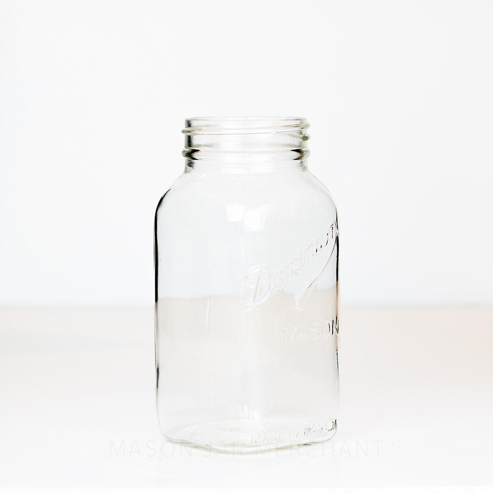Side view of a Dominion Mason regular mouth quart jar against a white background 