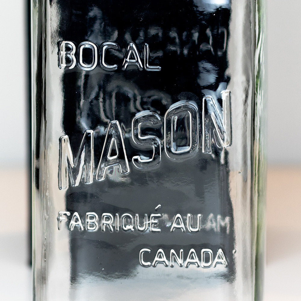 A close up of a Regular mouth quart mason jar with Canadian Mason logo, against a white background