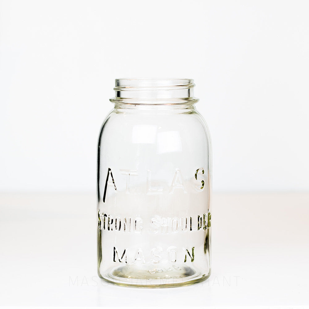 Vintage Atlas brand regular mouth quart mason jar on a white background