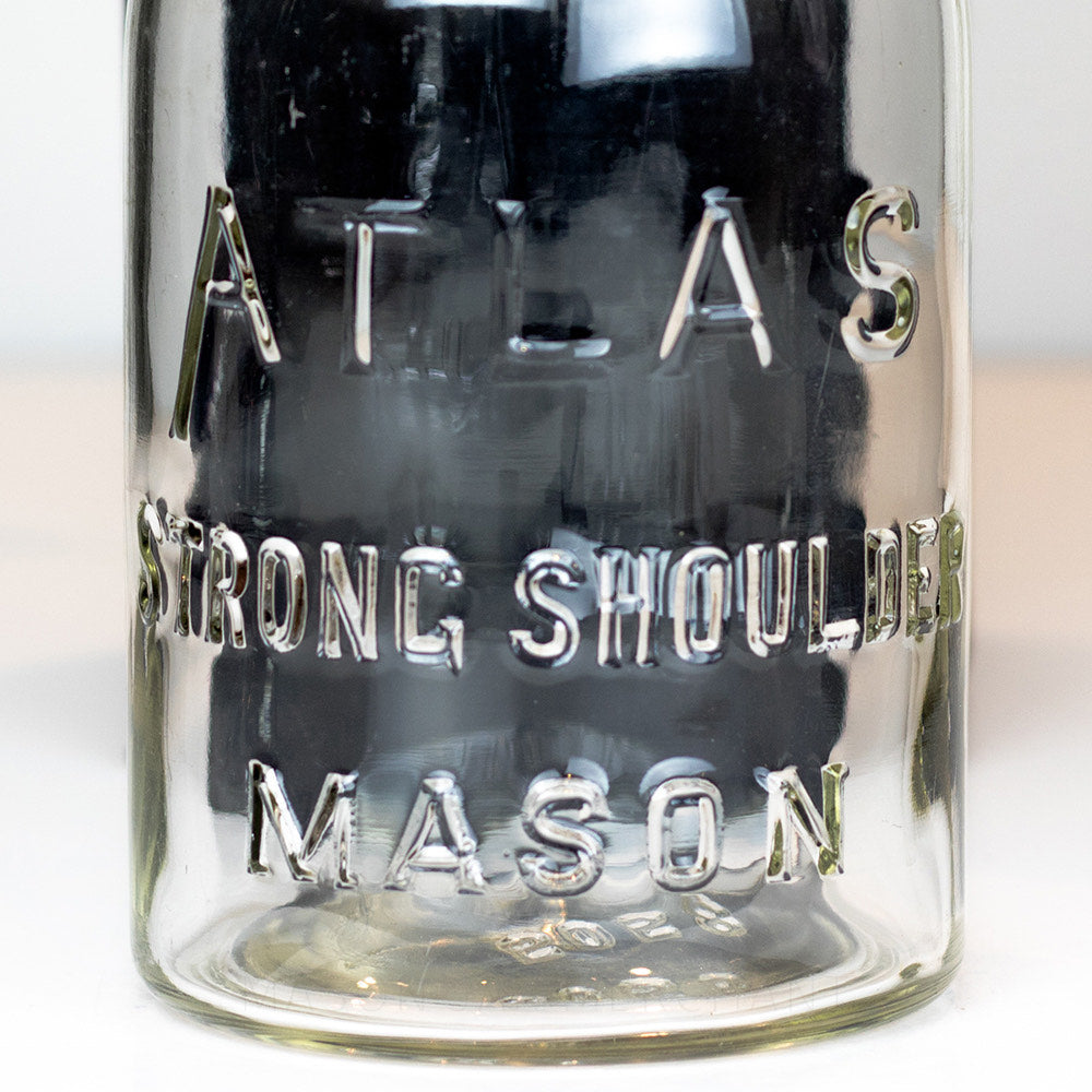 close up of a Vintage Atlas brand regular mouth quart mason jar on a white background