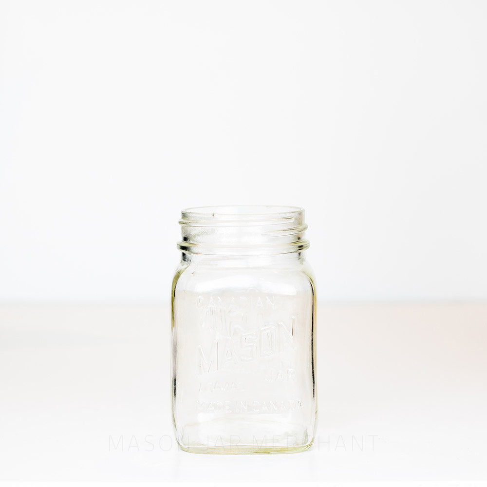 Regular mouth pint mason jar with Candian mason jar logo, on a white background