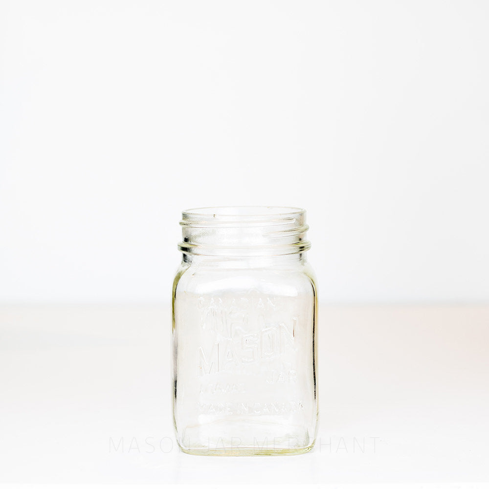 Regular mouth pint mason jar with Candian mason jar logo, on a white background 
