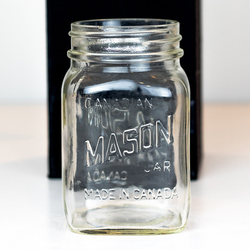 Regular mouth pint mason jar with Candian mason jar logo, on a white background 