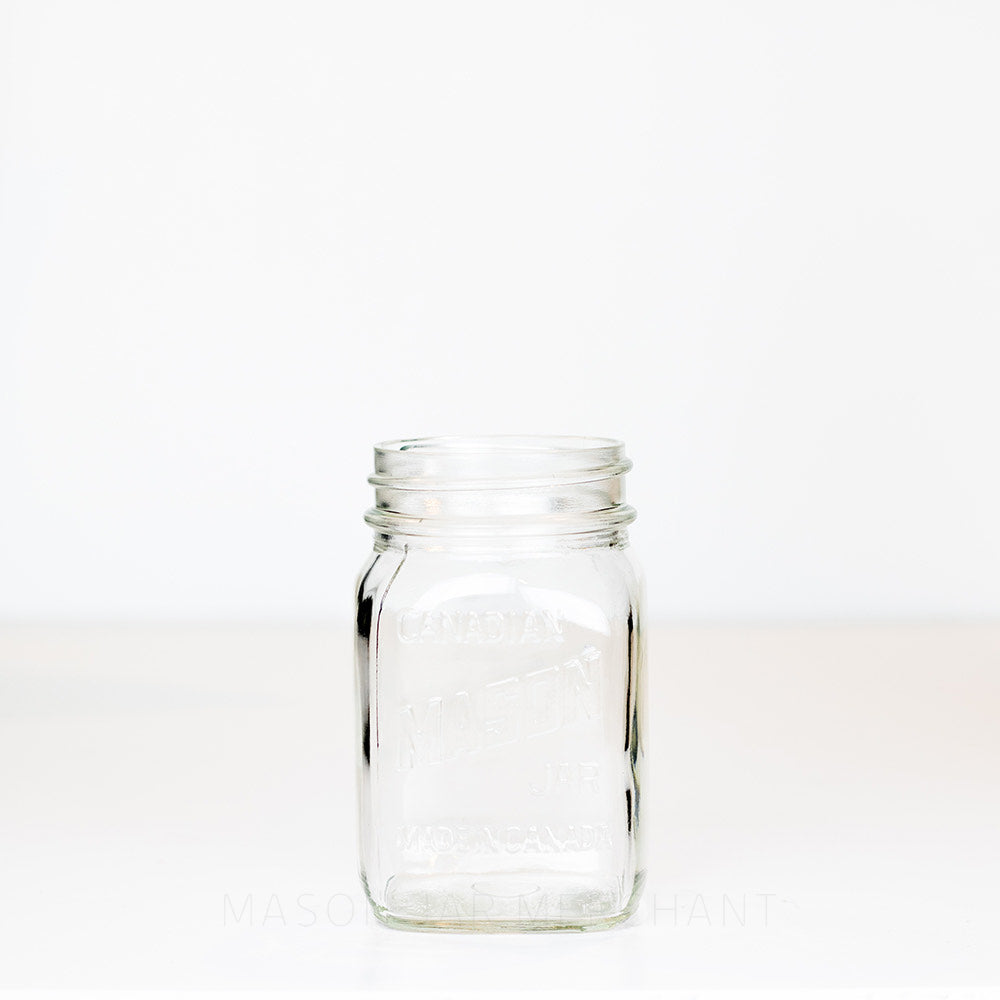 Regular mouth pint mason jar with Canadian Mason Jar, made in Canada logo, on a white background 