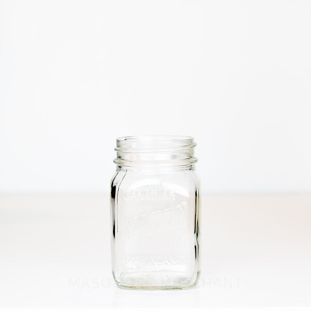 Regular mouth pint mason jar with Canadian Mason Jar, made in Canada logo, on a white background