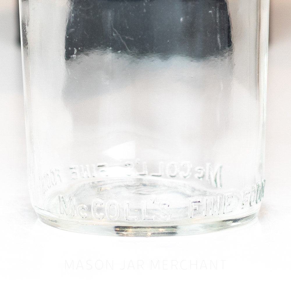 Bottom details of a Wide mouth pint mason jar against a white background