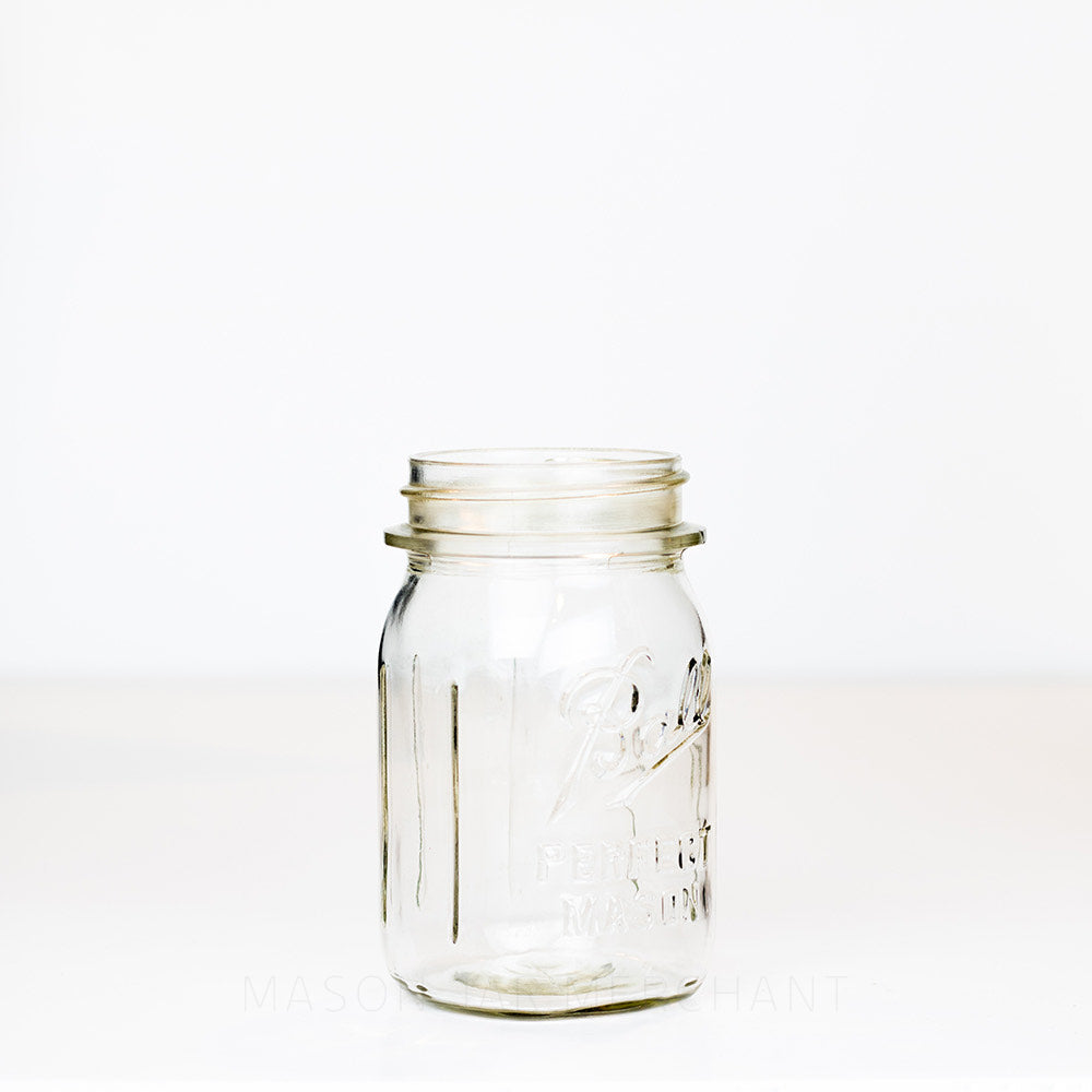 Side view of a Regular mouth pint mason jar with Ball Perfect Mason logo, against a white background