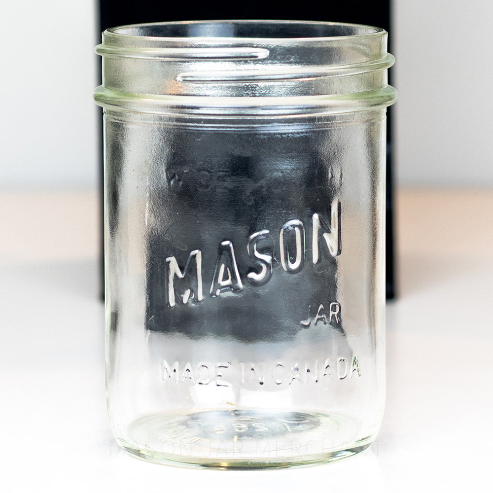 Wide mouth pint mason jar with Canadian Mason logo against a white background 