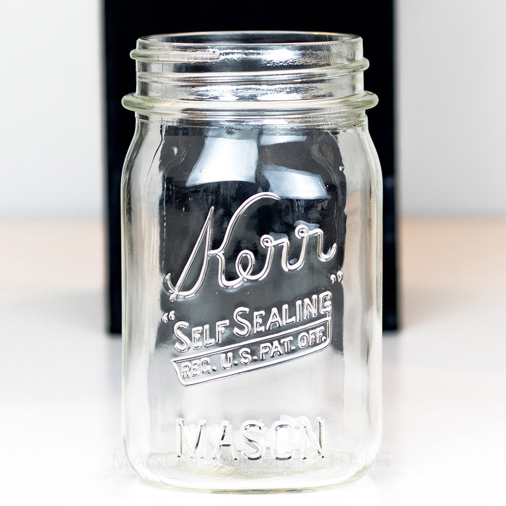 A close up of a Wide mouth pint mason jar with Kerr self-sealing logo
