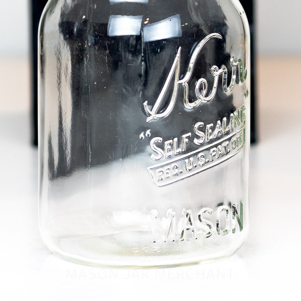 Side view of a Wide mouth pint mason jar with Kerr self-sealing logo