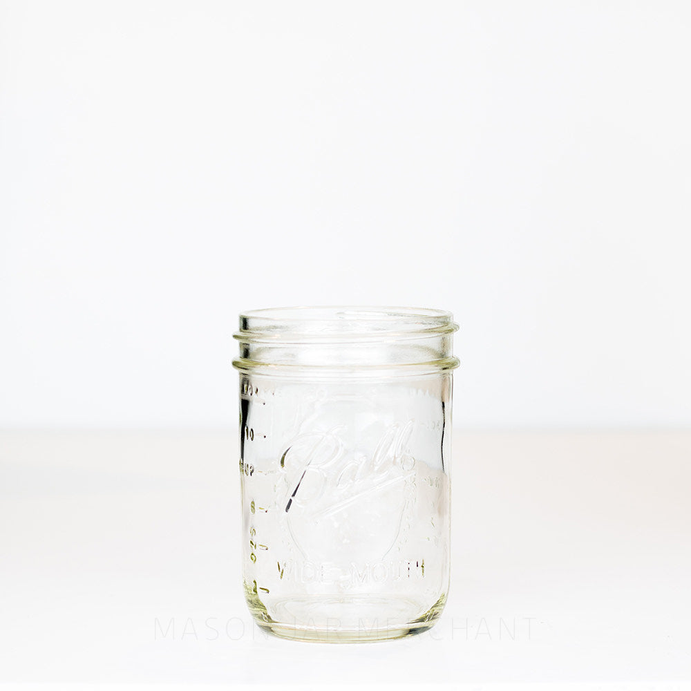 Ball wide mouth pint mason jar with logo showing, on a white background