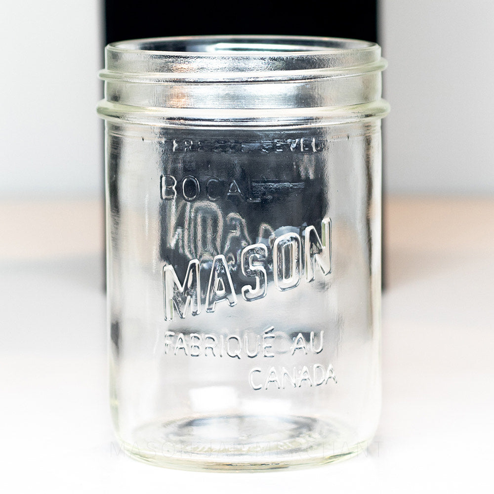 Close up of a Canadian mason wide mouth pint jar against a white background