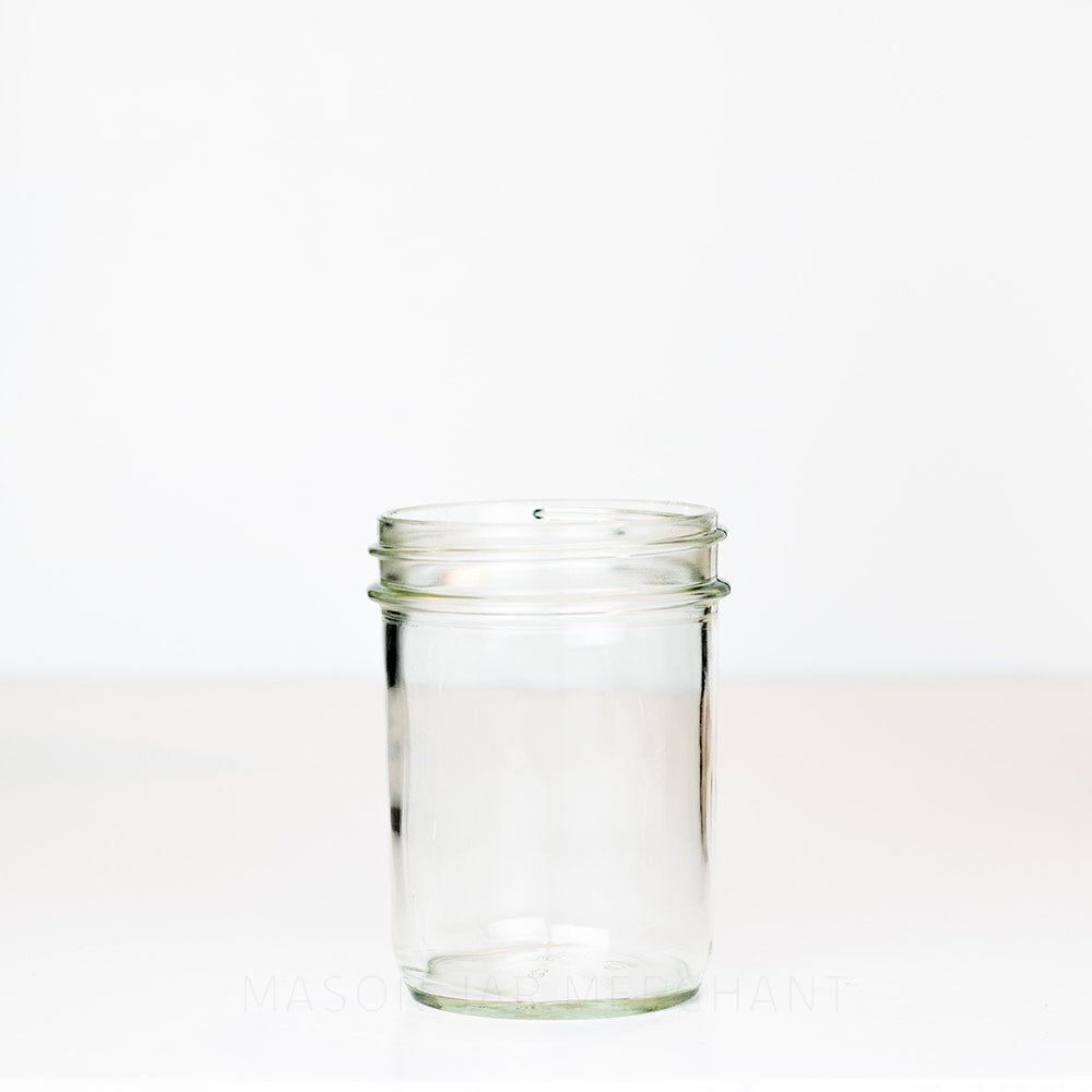 Plain Dominion wide mouth pint mason jar against a white background