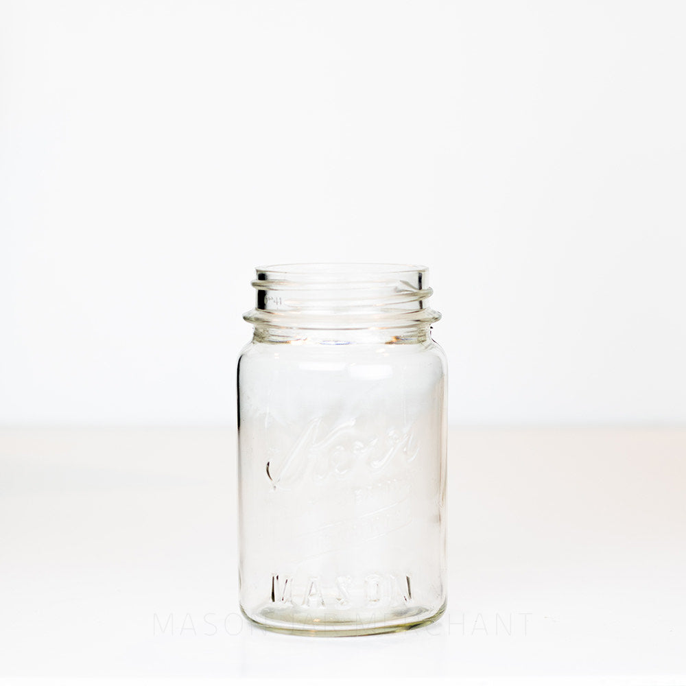 Vintage regular mouth pint mason jar with Kerr logo, on a white background 